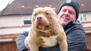 Dios the lilac Bully being held by his owner Aaron Oliver