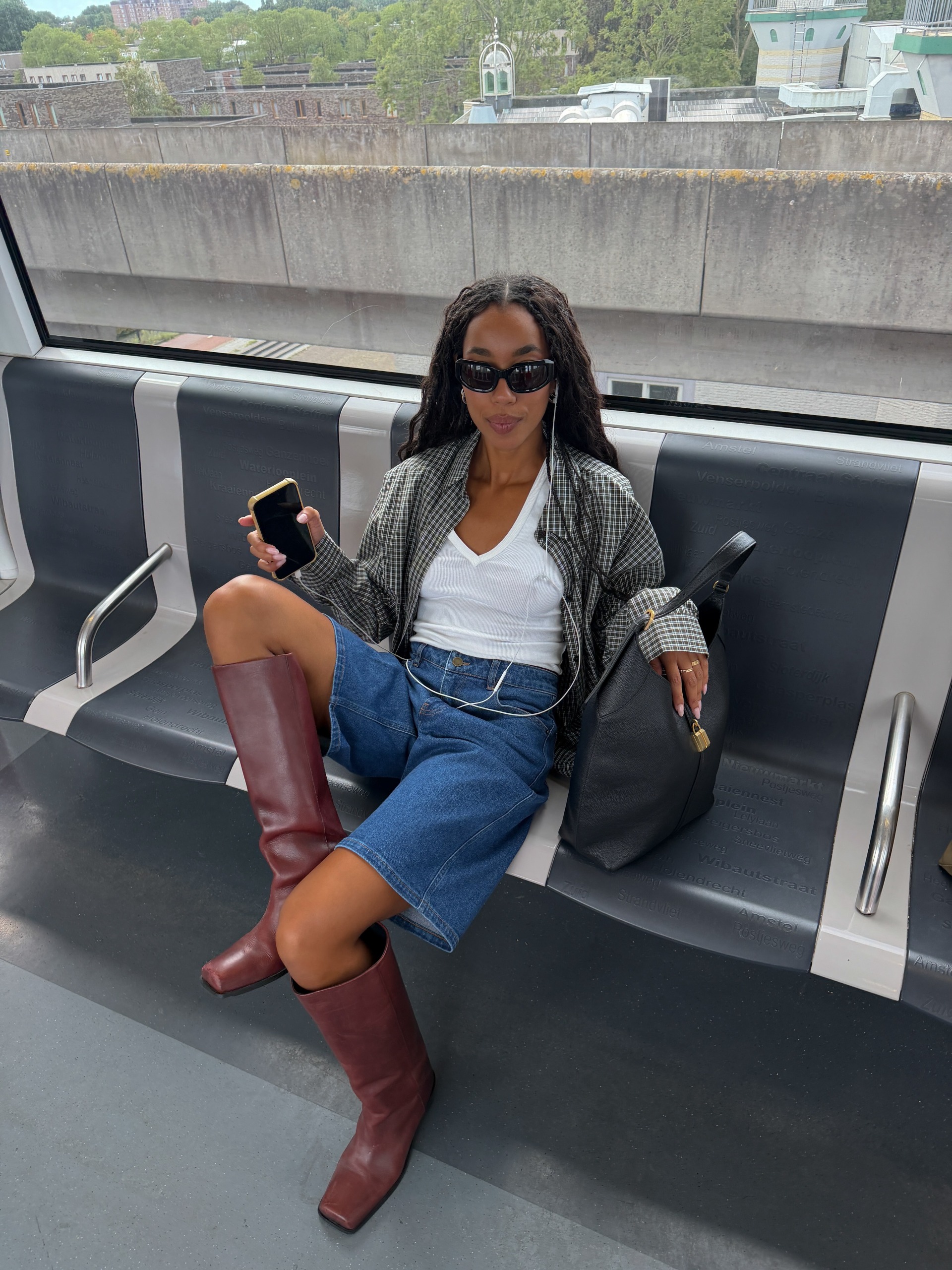 How to wear a plaid shirt 2026: casually cool. Fashion person @amaka.hamelijnck shows how to wear a plaid shirt in 2026. She styled it with a white tank top, blue denim Bermuda shorts, and red boots