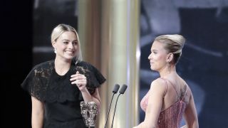 Margot Robbie presenting Scarlett Johansson an award at the 73rd British Academy Film Awards 