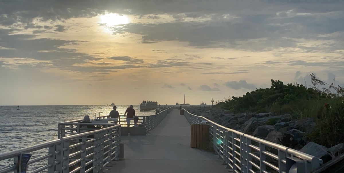 SpaceX's first Falcon 9 booster to fly six times returns home to Port Canaveral in Cape Canaveral, Florida on Aug. 21, 2020 atop the drone ship landing platform Of Course I Still Love You. The rocket launched 58 Starlink satellites and three Planet SkySats from Cape Canaveral Air Force Station on Aug. 18.
