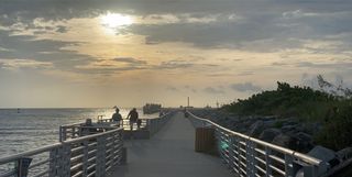 SpaceX's first Falcon 9 booster to fly six times returns home to Port Canaveral in Cape Canaveral, Florida on Aug. 21, 2020 atop the drone ship landing platform Of Course I Still Love You. The rocket launched 58 Starlink satellites and three Planet SkySats from Cape Canaveral Air Force Station on Aug. 18.