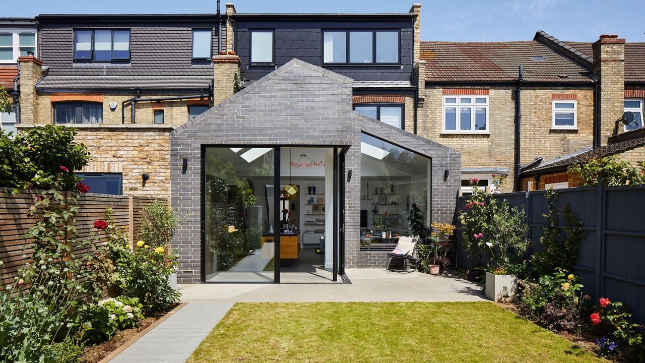 Looking at the back of a terraced brick house with a grey modern extension