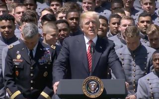 President Donald Trump presents the Commander-in-Chief's Trophy to the Army Black Knights college football team during a ceremony at the White House on May 1, 2018.