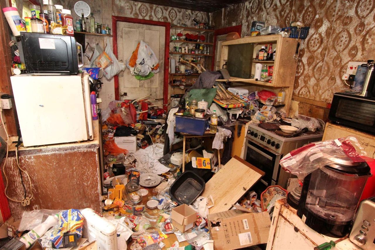 The living room is completely filled with rubbish so you can't see the floor