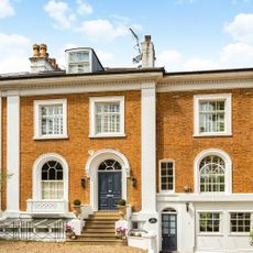 house exterior with white windows and grey door