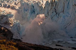 The immediate aftermath of the rupturing of an ice bridge connected to Argentina&#039;s Perito Moreno glacier, causing an enormous splash in the lake below.