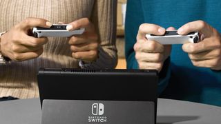 Joy-Con deals, two people play on a Nintendo Switch