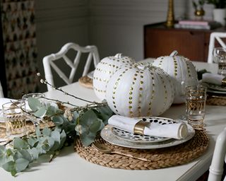 White pumpkin decorating ideas used as tablescape decor with gold thumbtack