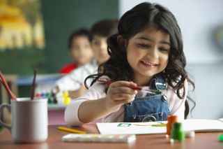 child painting at school