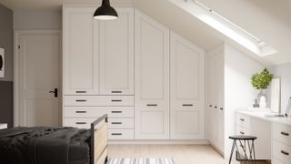 loft conversion bedroom with built in white shaker style wardrobes with slim black handles, white door, wooden and metal frame bed, black pendant light, velux window and cream carpet with striped rug