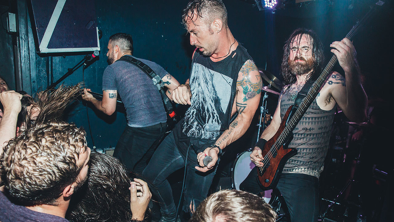 A photograph of Dillinger Escape Plan on stage