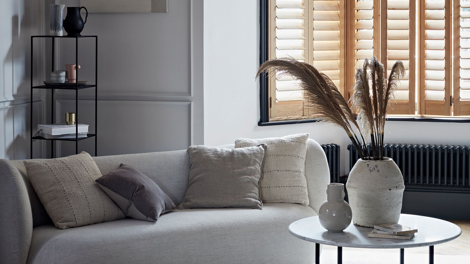 Japandi living room with natural unpainted wooden window shutters