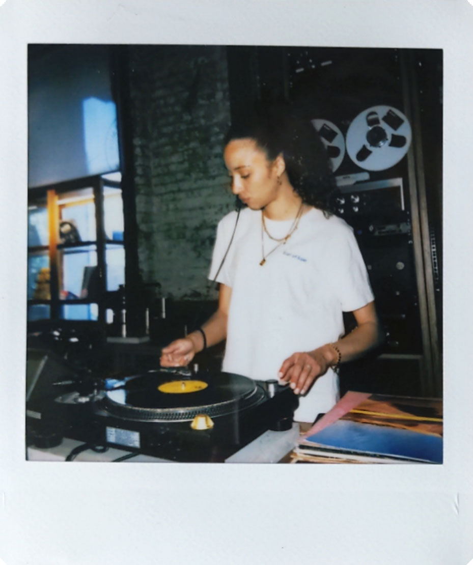 Digitized instant photo taken with the Fujifilm Instax SQ40 of DJ indoors in darkly lit bar