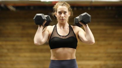 Woman using dumbbells for arm workout