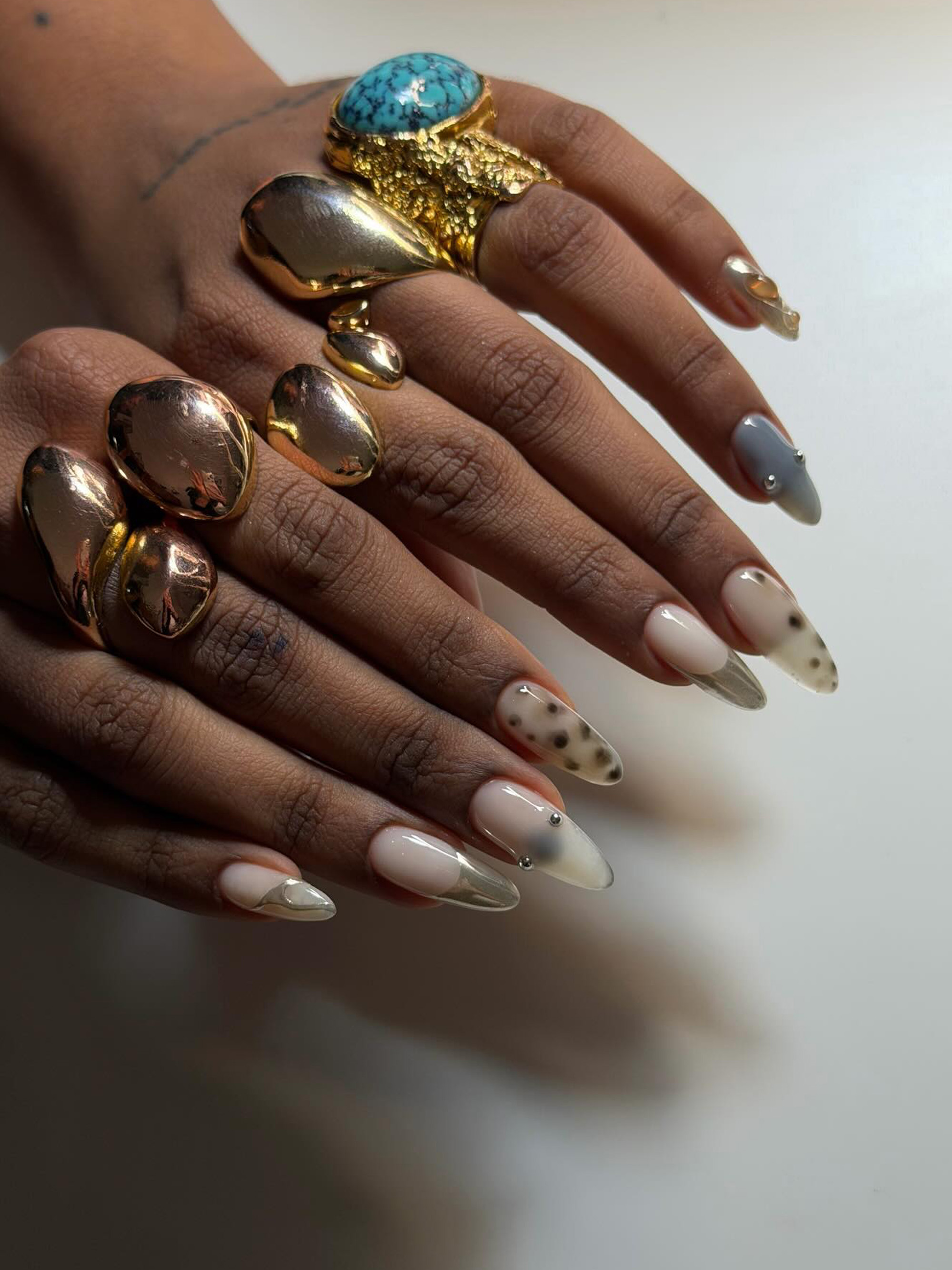 A mix-and-match manicure with chrome details by Oksana Zavora