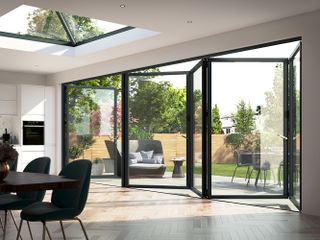 inside of a flat roof extension with a roof lantern and bi-fold door
