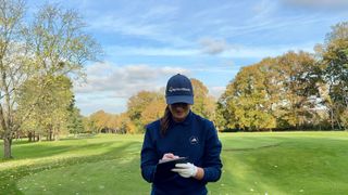 Jess Ratcliffe looking at scorecard