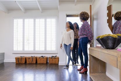 Estate agent showing a couple into a house