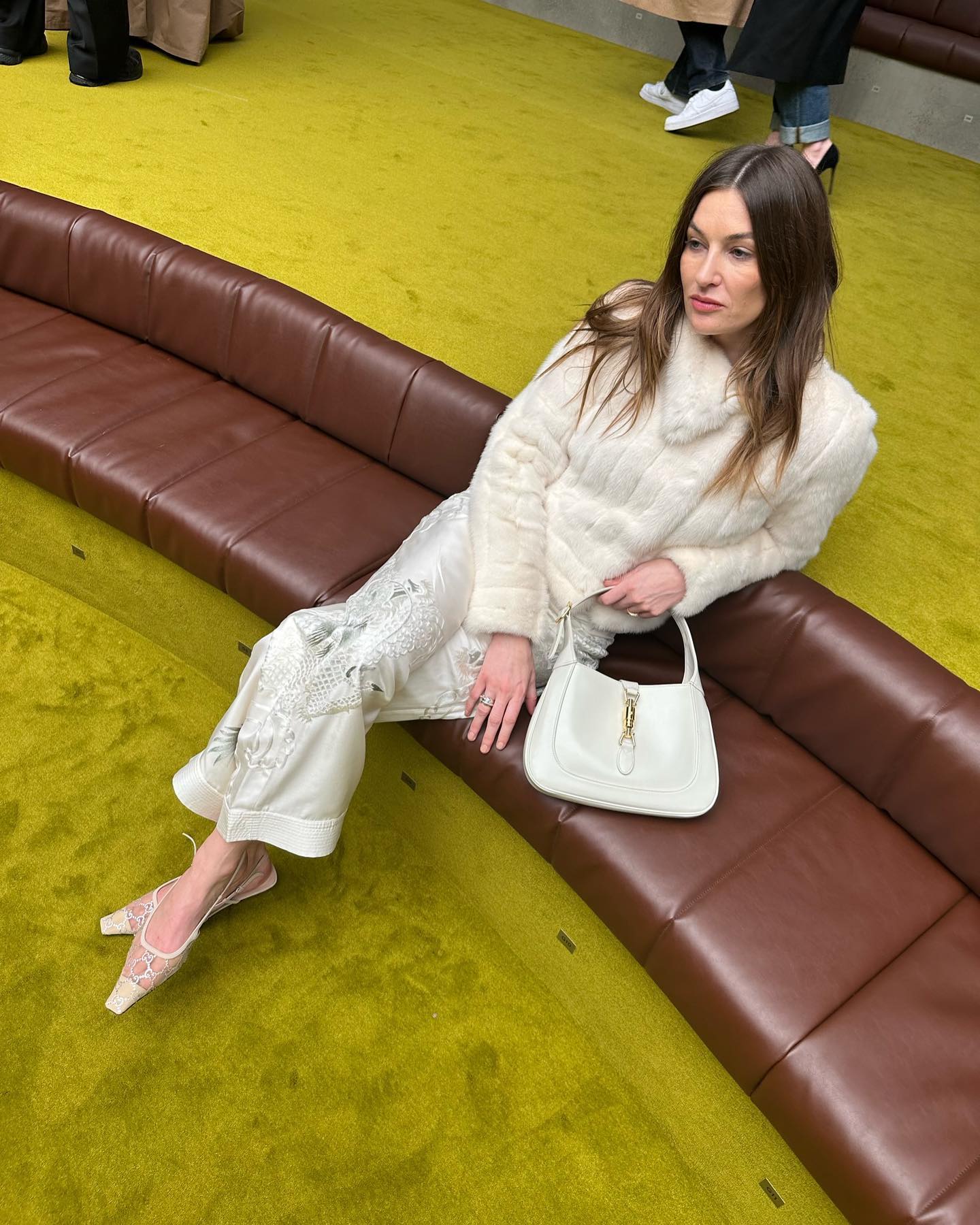 Camille Charriere wears a white Gucci Jackie bag.