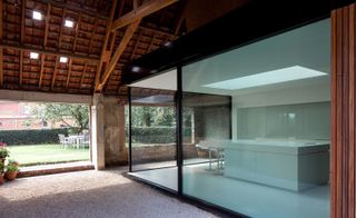 Glass walled room within barn structure
