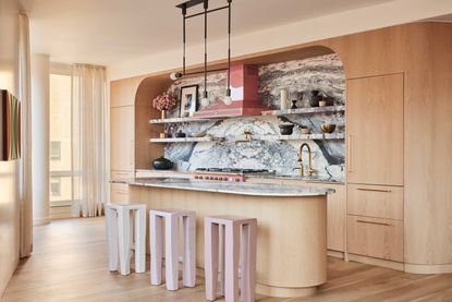 a kitchen with a bold marble backdrop