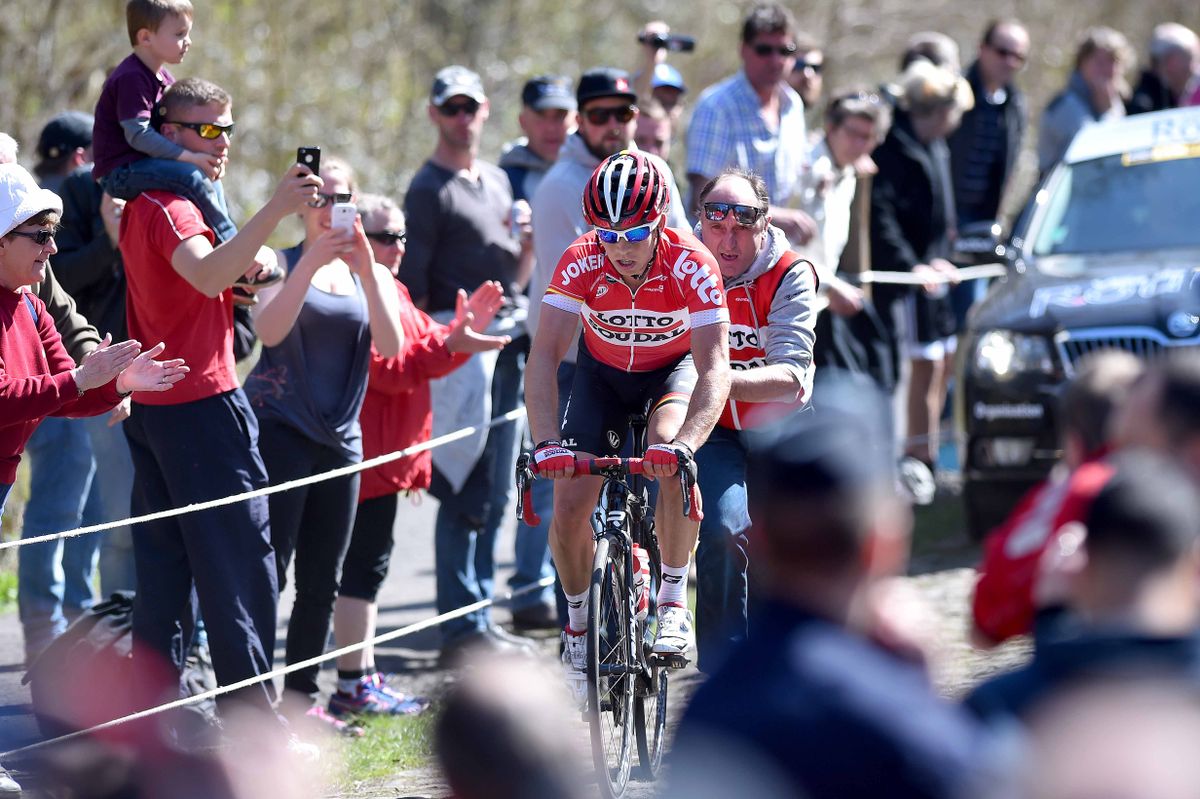 Sean De Bie (Lotto Soudal) gets back on after a flat in the Arenberg Forest