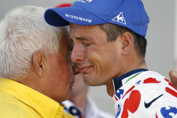 An emotional Johnny Hoogerland is comforted on the podium after receiving the polka dot jersey.