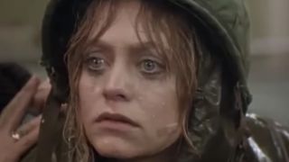 Close up of Goldie Hawn in an army helmet with a bandaid on her face in Private Benjamin