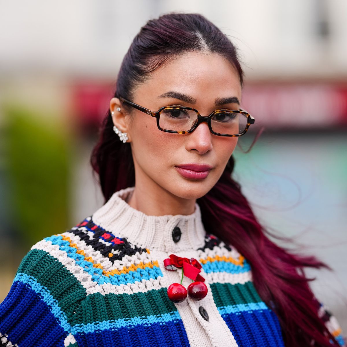 street style headshot of woman with deep burgundy hair