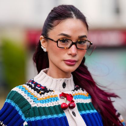 street style headshot of woman with deep burgundy hair