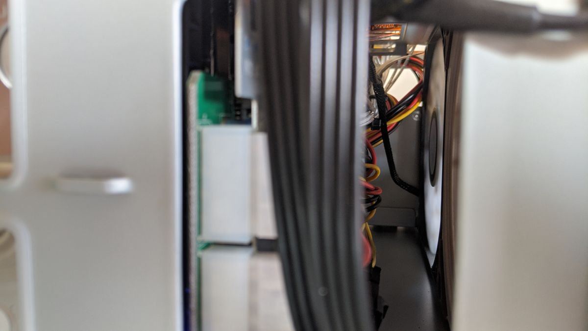 The back area between the fans and HDD boards. I manged to push the cables above and below the boards (including the PSU extender in the foreground) to allow clear airflow for the fans.