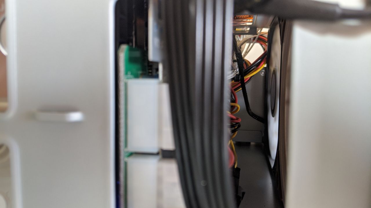 The back area between the fans and HDD boards. I manged to push the cables above and below the boards (including the PSU extender in the foreground) to allow clear airflow for the fans.