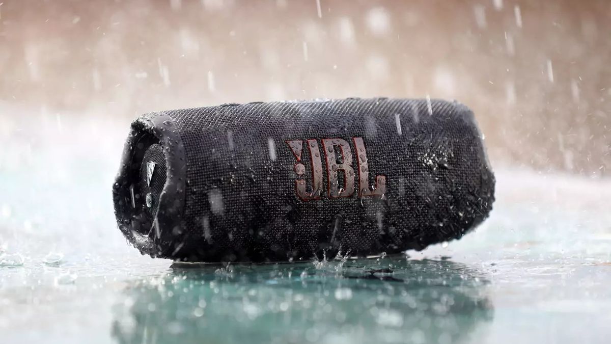 JBL Charge 5 Bluetooth speaker on the ground outdoors in the rain