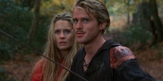 Westley (Cary Elwes) brandishes his sword while standing in front of Buttercup (Robin Wright) in 'The Princess Bride'