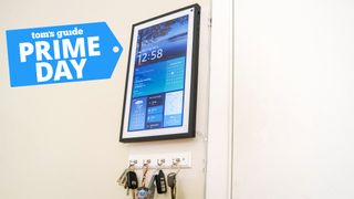 An Amazon Echo Show 15 mounted to a kitchen wall with a Prime Day deals badge