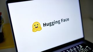 Hugging Face logo and branding pictured on a laptop screen on white background.