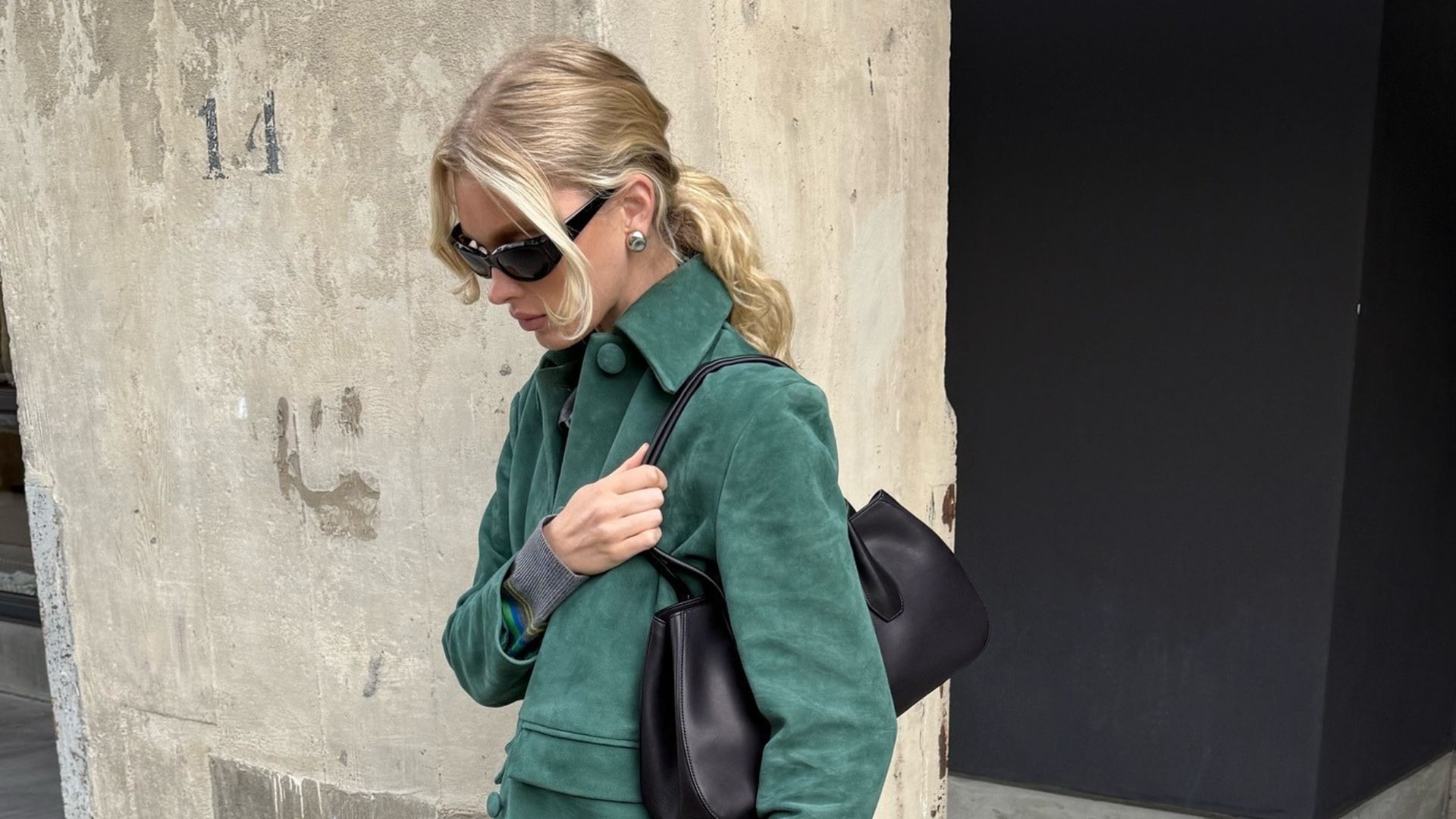 Model Elsa Hosk wears a dark green suede jacket with straight-leg jeans and heeled ballet pumps.