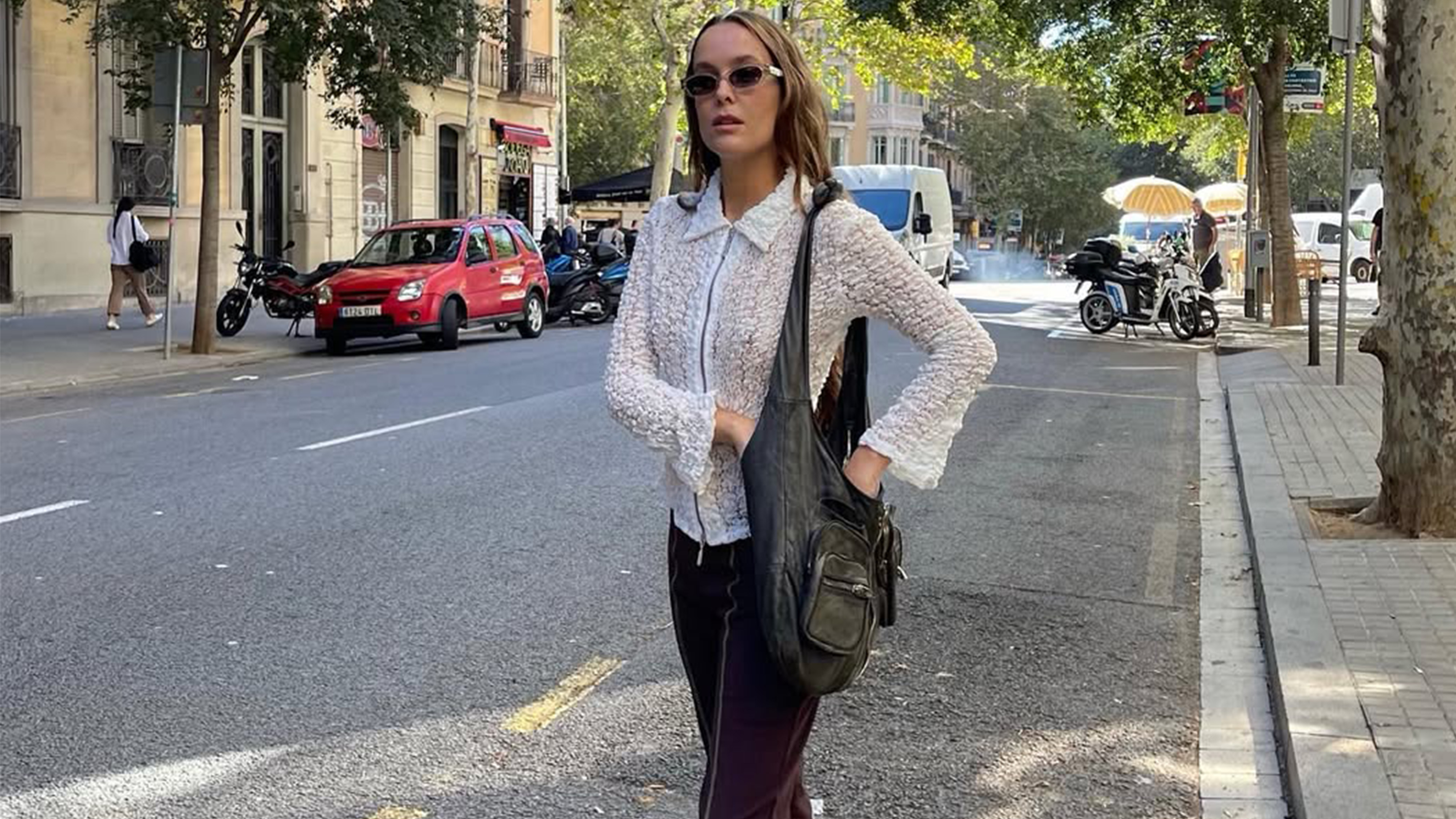 Helena Cuesta wearing capris and a zip-front top with sunglasses.