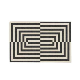 A rectangular black and white striped rug