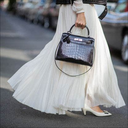 woman in white maxi skirt and white heels