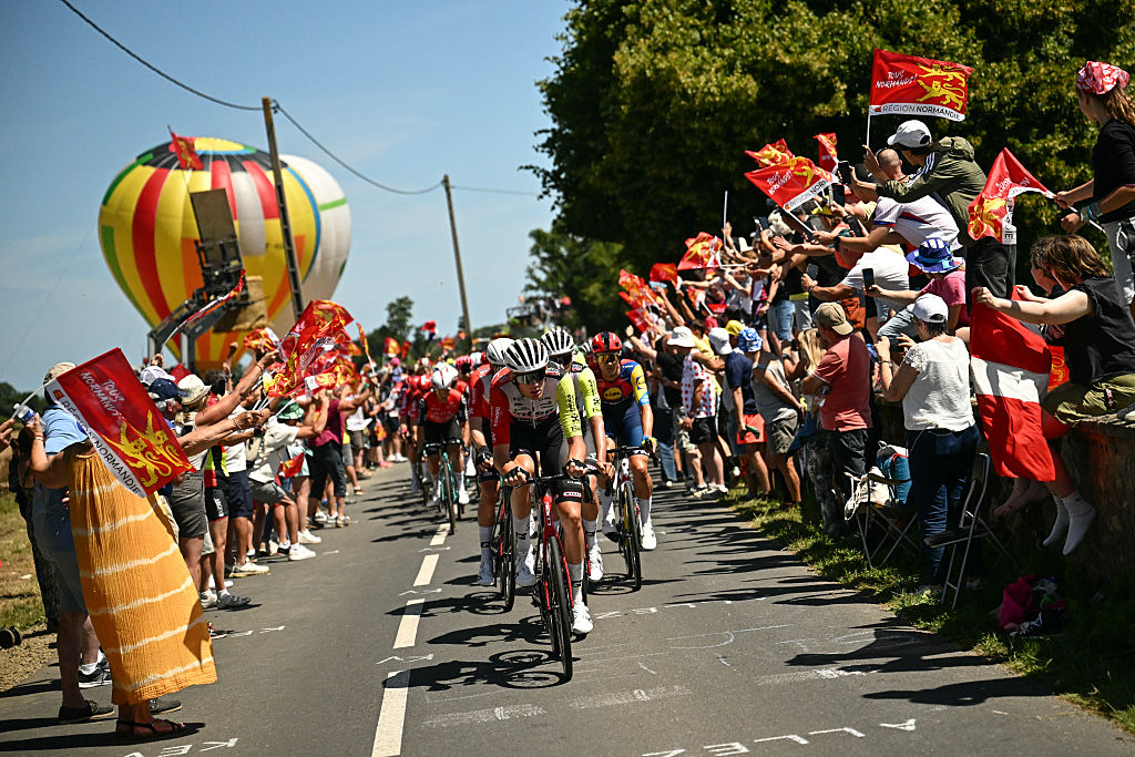 Intermarche -Wanty team riders lead the pack of riders (peloton) during the 6th stage of the 112th edition of the Tour de France cycling race, 201.5 km between Bayeux and Vire Normandie, Northwestern France, on July 10, 2025. (Photo by Loic VENANCE / AFP)