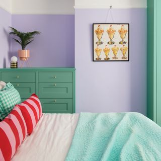 colour wheel ideas, harmonious colours, lilac bedroom with mid green chest of drawers/wardrobe, pink and red stripe cushions, ice cream artwork