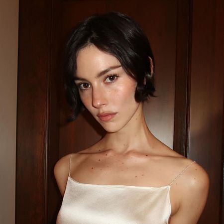 A photo of Gracie Abrams wearing a white dress