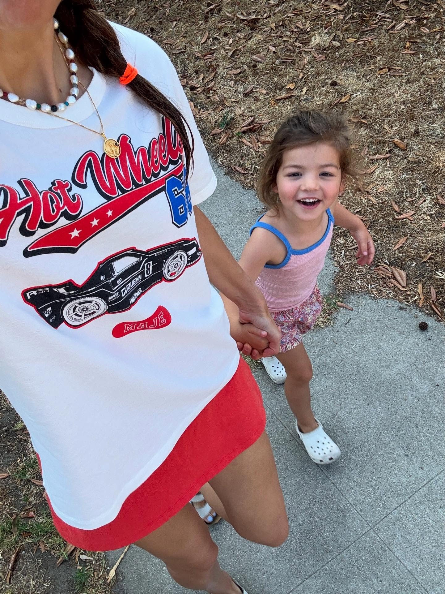Woman in graphic t-shirt and red skirt
