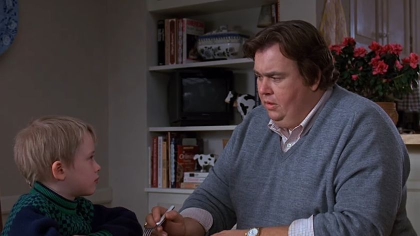 Macaulay Culkin and John Candy talking at a table in Uncle Buck