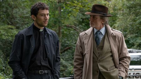 From left to right: Josh O'Connor in Wake Up Dead Man looking forward and Daniel Craig looking at Josh O'Connor. They are standing next to each other. 