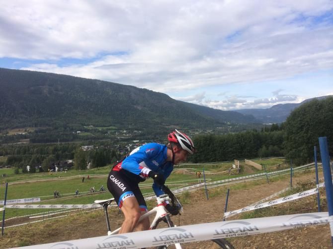 A Canadian rider climbs the open, grassy switchbacks.