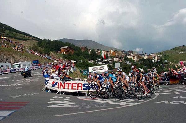 A group of dropped riders comes up the climb