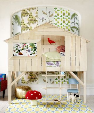 Unique bedroom ideas for boys, with a wooden treehouse bed and multiple different green and white wallpaper patterns.
