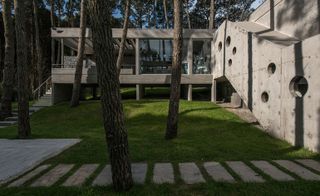 house with circular openings in the concrete corridor
